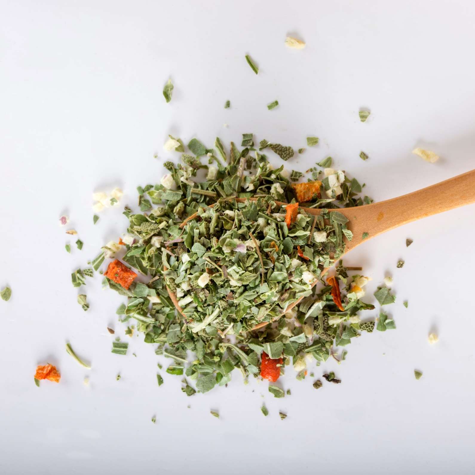 Spoon with dried oregano and thyme, basil and vegetables